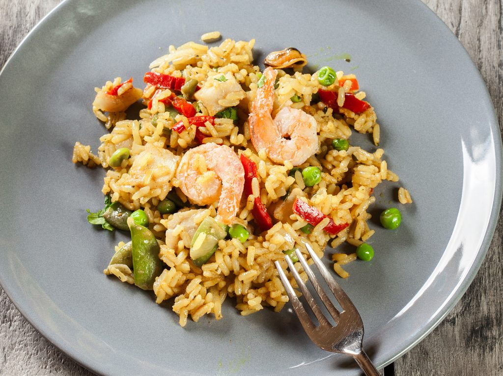 Traditional seafood paella with shrimp, fish and chicken seved i