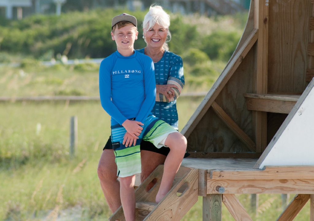 Pat Bradford and grandson Ethan in 2017, photographed in WB stand #12
by Allison Potter. Ethan participated in Jeremy Owens’s Ocean Rescue
Junior Lifeguard camp two memory-filled summers, 2017-2018. WB file photo.