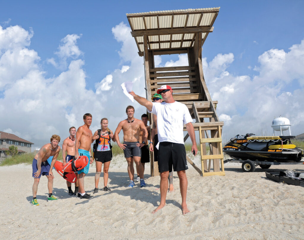 Wrightsville Beach Ocean Rescue captain Jeremy Owens directs a team on its next task during the grueling Lifeguard Challenge in May 2012. WBM file photo.