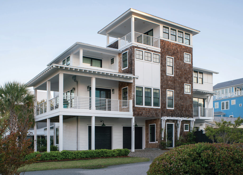 Built by The Pioneer Group, this five-bedroom, five-and-a-half bath beach home is located across the street from the ocean in Carolina Beach and features a rooftop lookout. Clean modern lines are paired with the classic beach house look of cedar shakes that take on a patina with age.
Photo by Harry Taylor