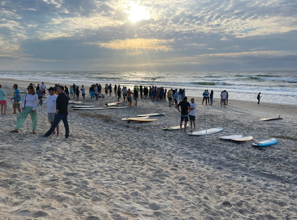 A paddle out to celebrate Kevin’s life was held on June 5, 2022 at sunrise in front of the Surf Club, Wrightsville Beach. An estimated 200 attended, including at least four of his TKE fraternity brothers. Approximately 40 participated in the paddle out itself. Photo by Pat Bradford