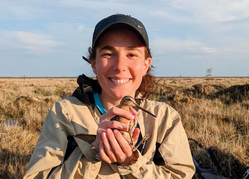 Field tech Lucie le Tallec holds a short-billed dowitcher near Churchill, Canada, just a few weeks before the same bird would show up at Audubon’s Lea Island Sanctuary. Photo by Olivia Maillet