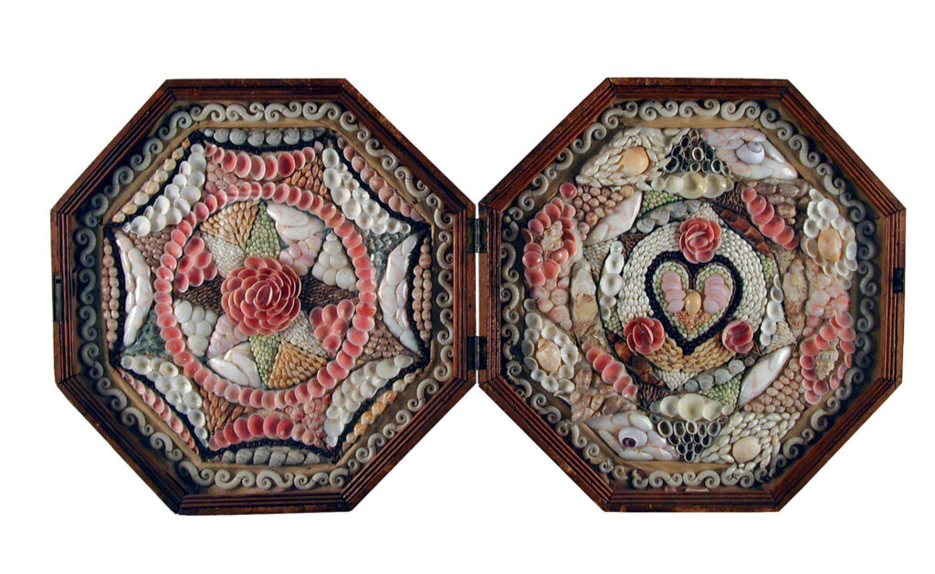 Originating in Barbados, this c. 1830  sailors’ valentine was owned by Margaret Woodbury Strong, founder of the Strong Museum in New York. It features a stained Spanish cedar case with a glass cover.  It is patterned with colored cardboard,  multicolored shells and crab’s eyes, or seeds. Courtesy of The Strong museum, Rochester, New York
