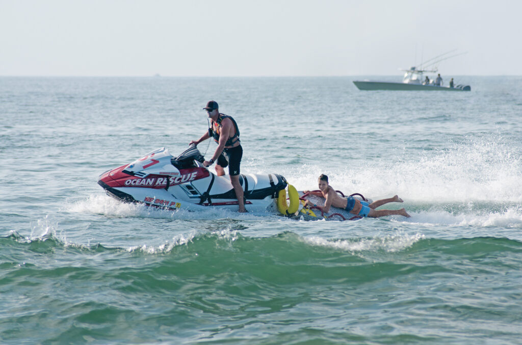 Jeremy demonstrates a jet ski rescue with a camp participant during the 2018 Junior Lifeguard Program. WBM File Photo