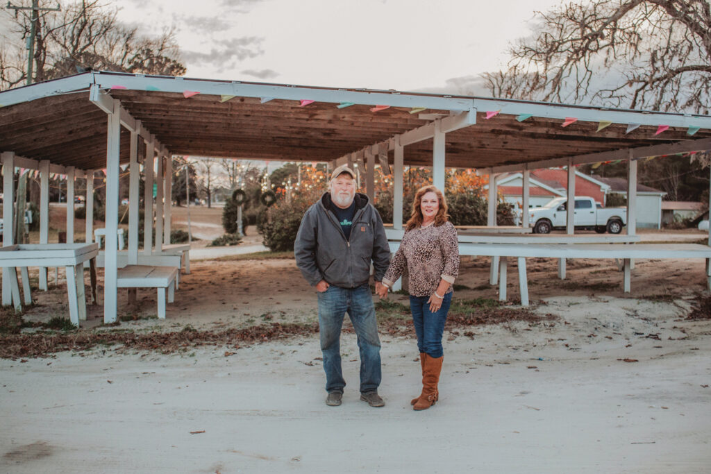 Ronnie and Sharon in front of their produce stand in December 2022. The couple have three sons, Ronnie Jr., Jeremy and Ethan. Courtesy Edens Family/©Lori & Erin Photography