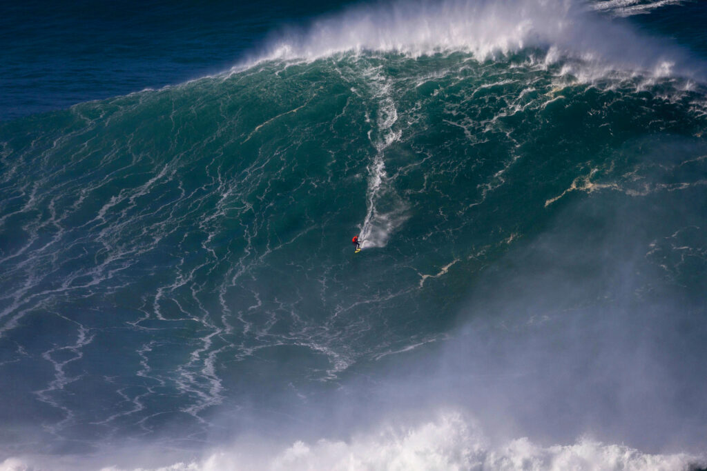 Mason Barnes surfs in Nazaré, Portugal in 2022. The 100-foot wave is in contention for the Guinness World Record for biggest wave ever surfed. Courtesy Mason Barnes