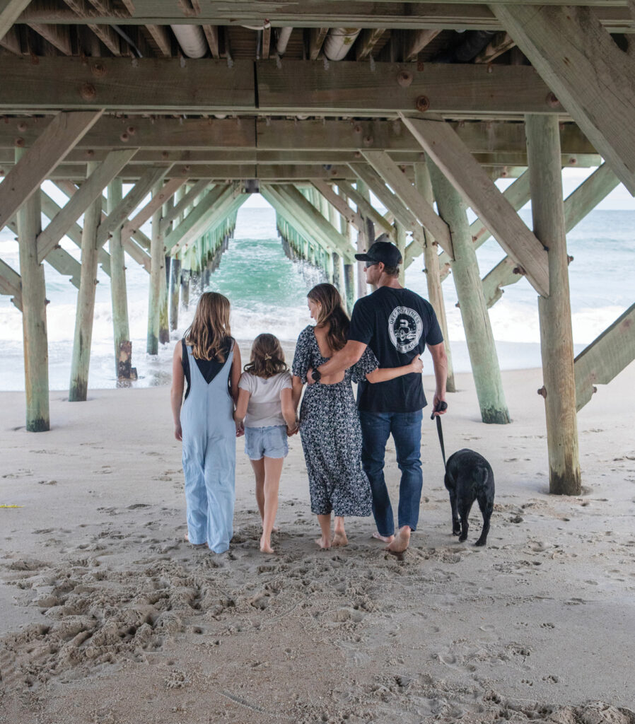 Veteran Blake Reynolds, seen here with his family and service dog at Wrightsville Beach.